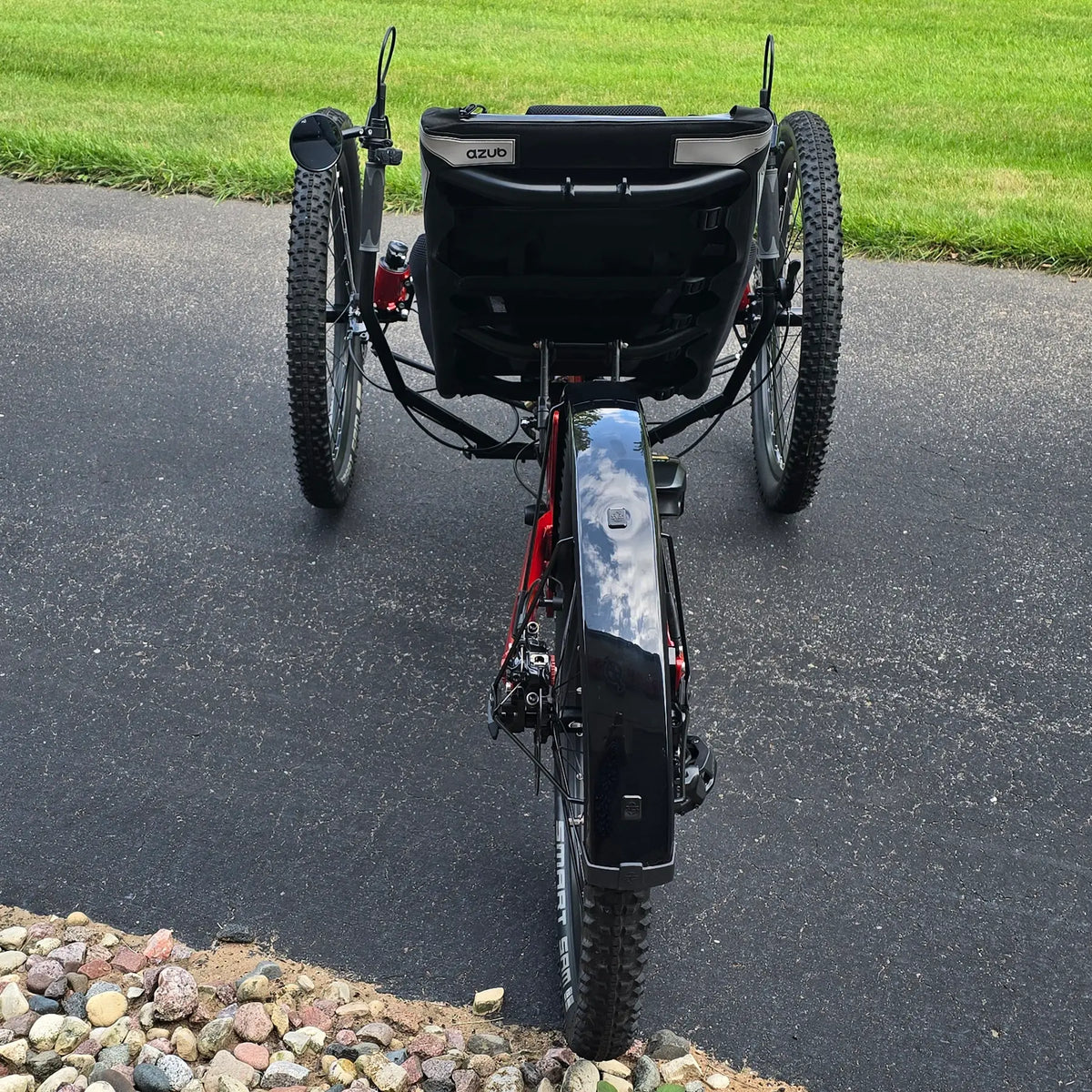 Rear view of the Azub Demo Ti-Fly X Shimano EP6 Ruby Red Recumbent Trike in an outdoor setting.