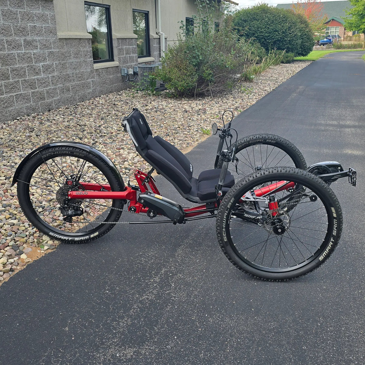 Side view of the Azub Demo Ti-Fly X Shimano EP6 Ruby Red Recumbent Trike in an outdoor setting.