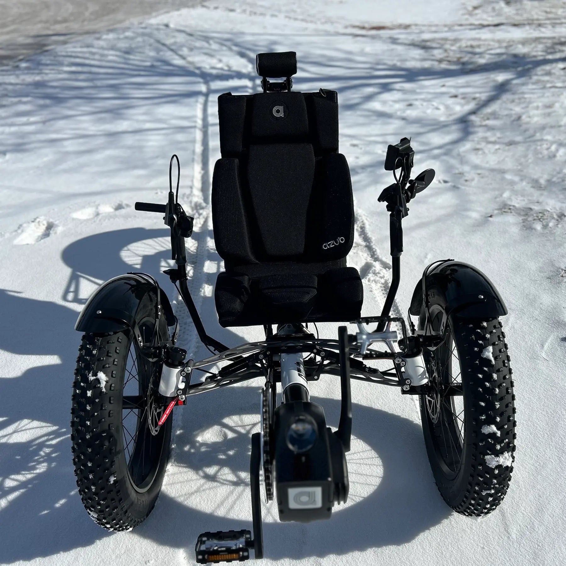 Front view of the Azub Limited Edition Ti-Fly recumbent trike on a snowy path.