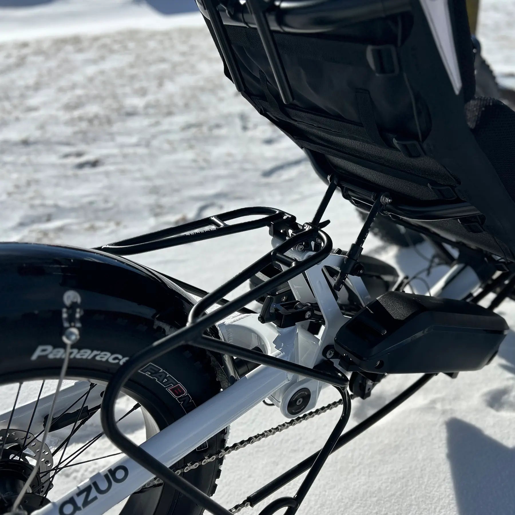 Closeup of the rear rack and Bosch Dual Batteries on the Azub Limited Edition Ti-Fly recumbent trike on a snowy path.