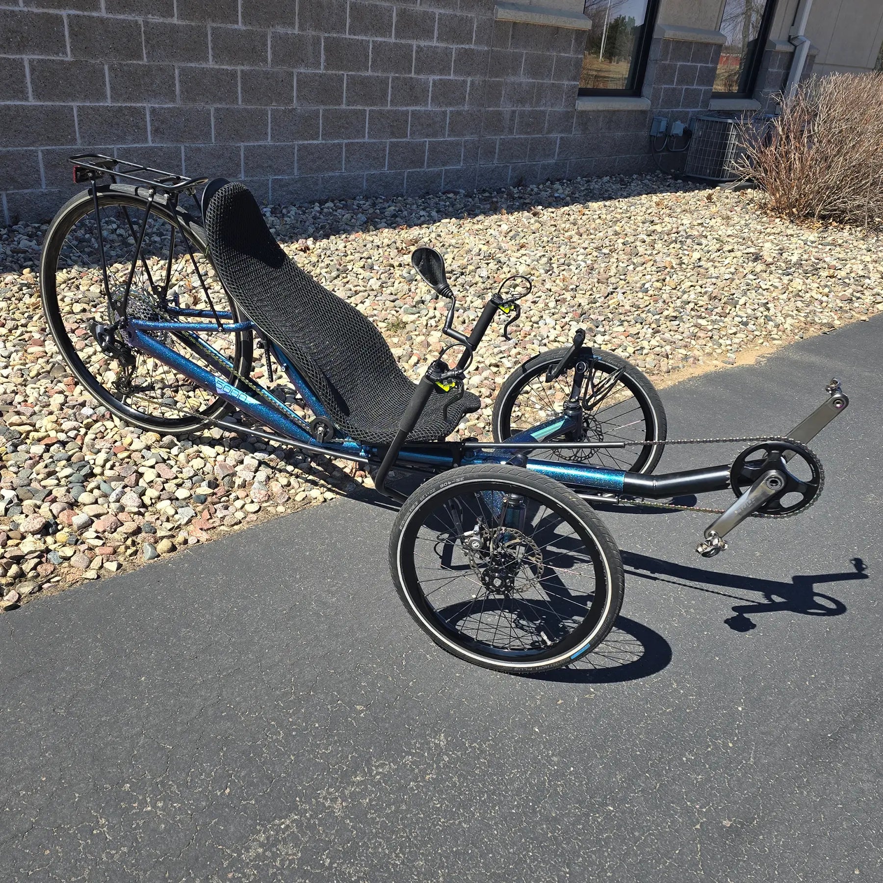 Angled side view of the Azub Used T-Tris 5000 Chameleon Teal Custom Recumbent Trike in an outdoor setting.