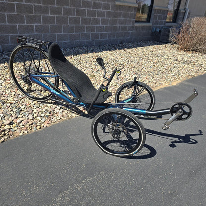 Angled side view of the Azub Used T-Tris 5000 Chameleon Teal Custom Recumbent Trike in an outdoor setting.