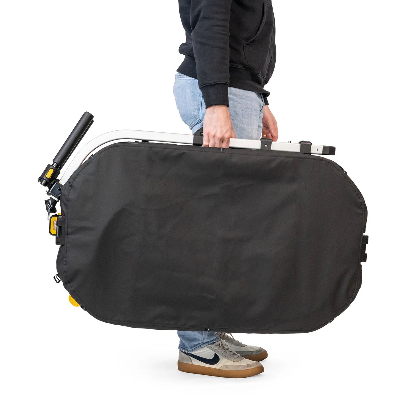 View of the Burley Hopper Cargo Trailer, shown folded in its carry bag being carried by a man, with a white background.