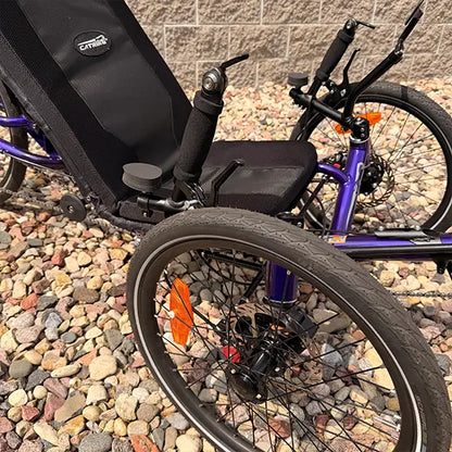 Closeup front view of the Catrike Demo Dumont Compact Candy Purple Recumbent Trike in an outdoor setting.