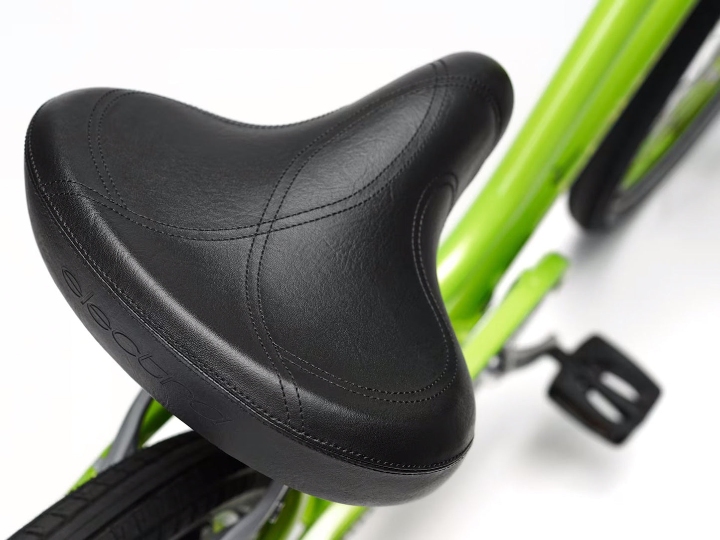 Detail view view of the saddle of the Electra Townie 7D Step-Thru 26 Inch Wheeled Bike in Kiwi, shown on a white background.