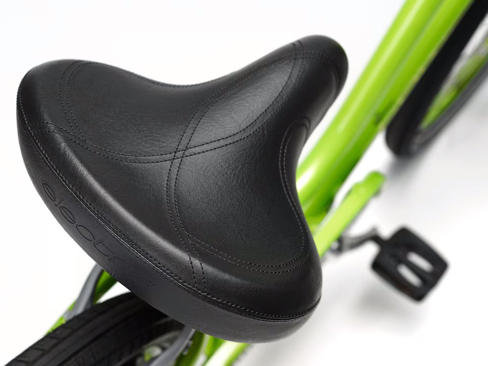 Detail view view of the saddle of the Electra Townie 7D Step-Thru 26 Inch Wheeled Bike in Kiwi, shown on a white background.