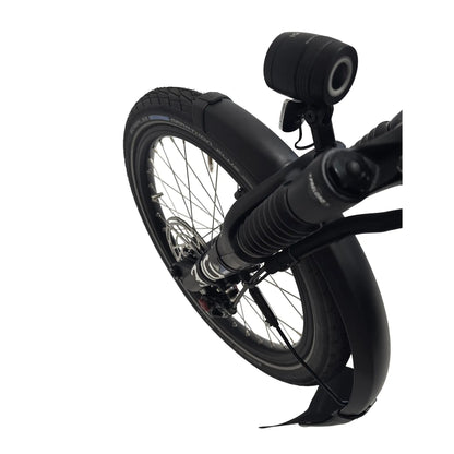 Closeup view of the headlight, front suspension and wheel on the Hase Kettwiesel One Plus Enviolo Bosch Performance CX Pale Green Recumbent Trike against a white background.