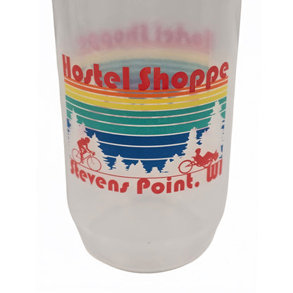 Closeup view of a clear Hostel Shoppe custom water bottle with red cap and colorful design against a white background.