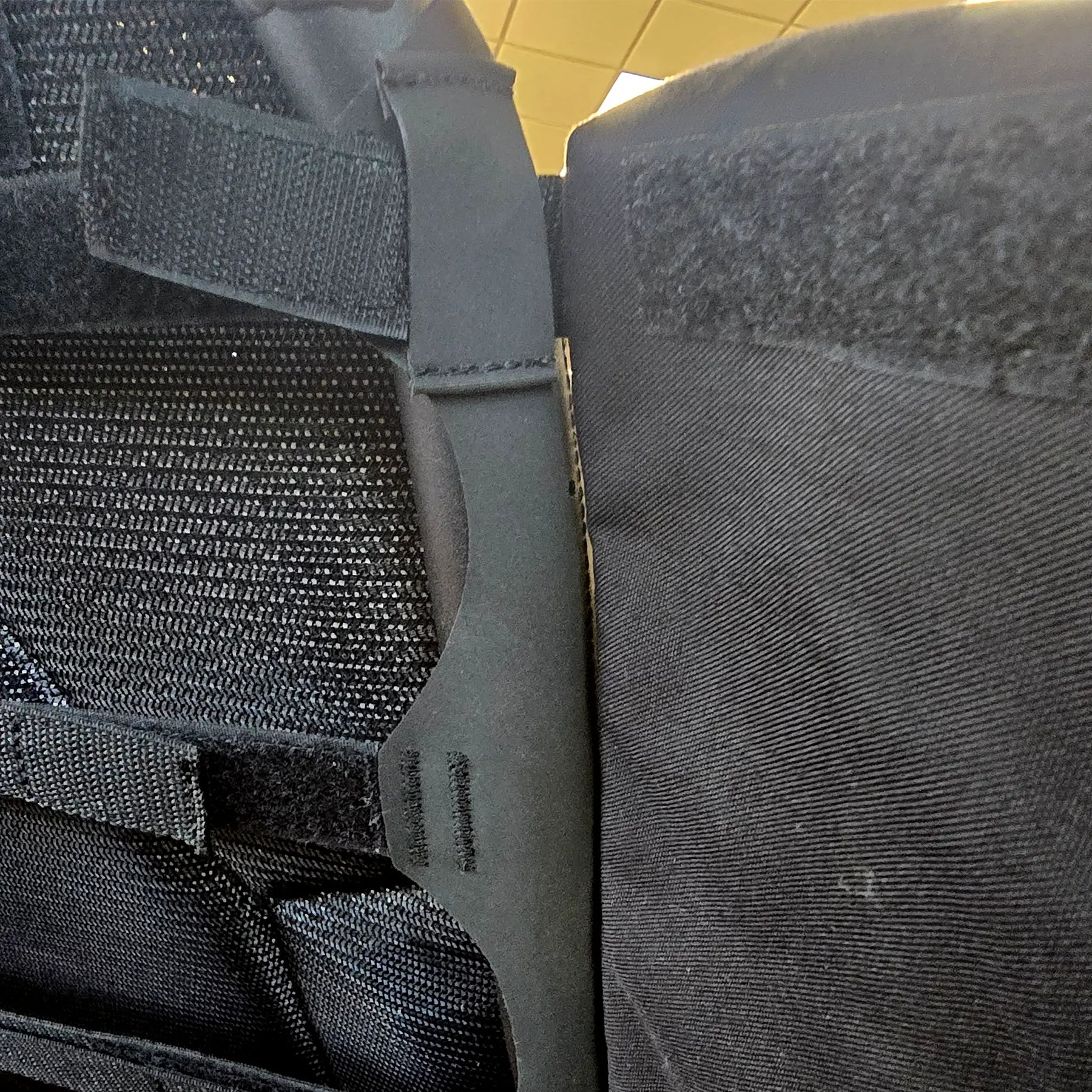 Closeup view of attachment loop and Velcro on the HP Velotechnik Add-On Bags for Mesh Seat in black mounted on a trike.