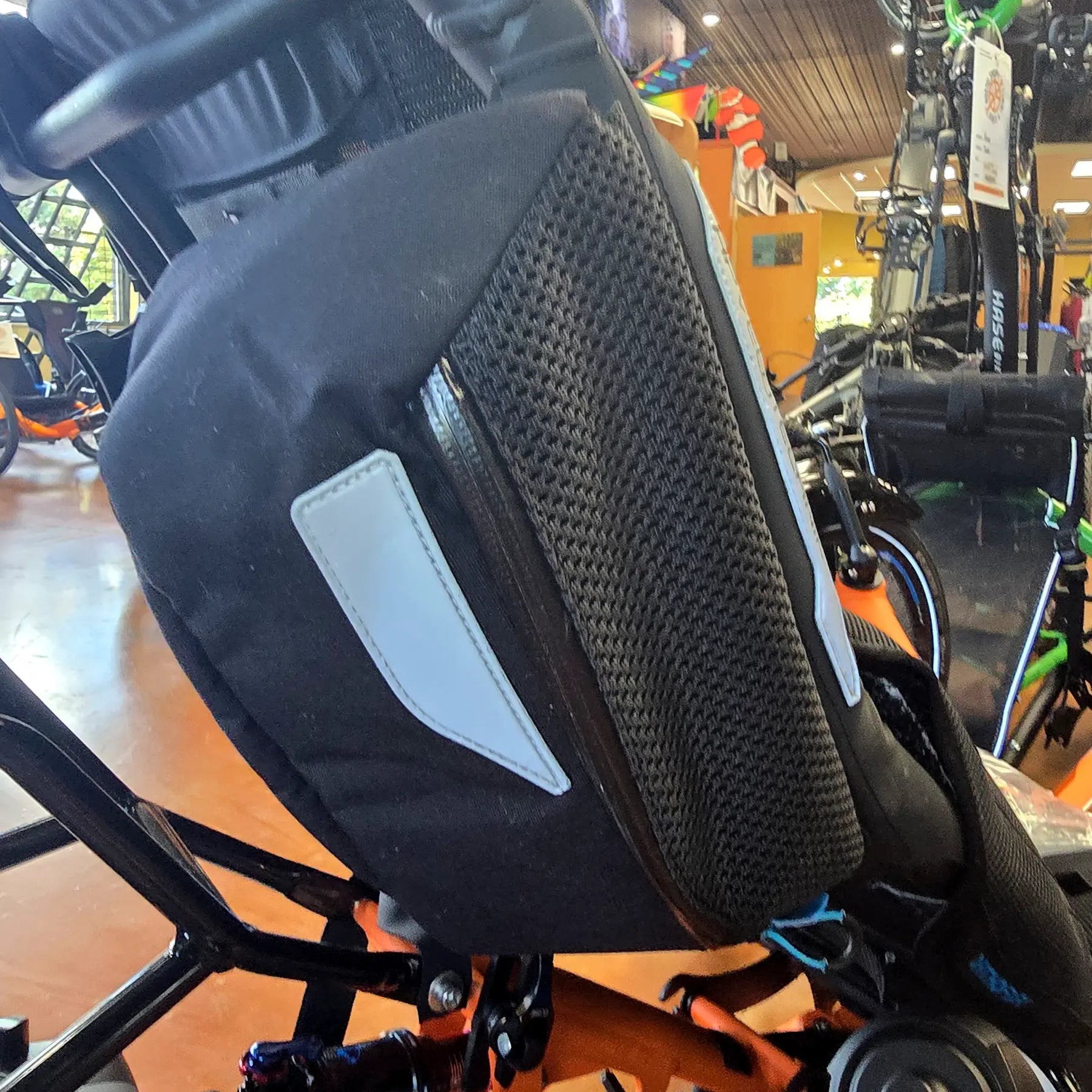 Closeup view of the mesh topped bag in the pair of the HP Velotechnik Add-On Bags for Mesh Seat in black mounted on a trike.