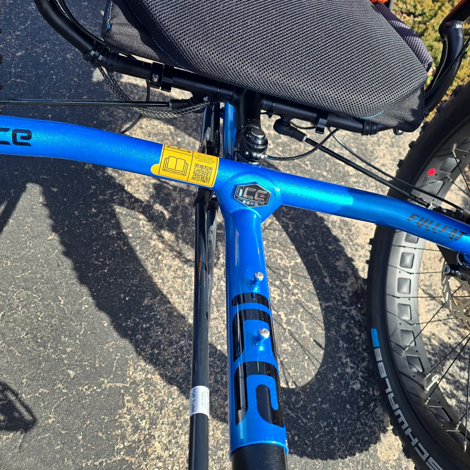 Closeup view of the frame on the ICE Full Fat RS Rohloff Shimano EP8 Hostel Shoppe Limited Edition Custom Blue Recumbent Trike outside in front of the Hostel Shoppe.