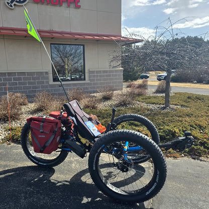 Side view of the ICE Full Fat RS Rohloff Shimano EP8 Hostel Shoppe Limited Edition Custom Blue Recumbent Trike outside in front of the Hostel Shoppe.