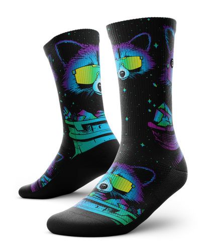 Pair of black socks printed with heads of racoons wearing yellow sunglasses and garbage cans.  Racoons and garbage cans are colored in blues, purples and teals.
