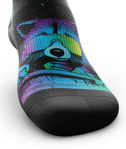 Front top of a black sock with a racoon head in blue, purple and teal wearing yellow sunglasses. 