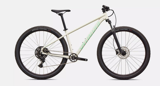 White Specialized Rockhopper Sport mountain bike with black components on a light gray background