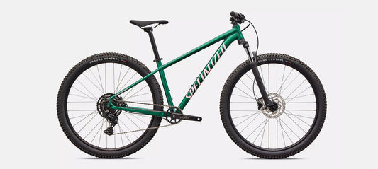 Right profile of green Specialized Rockhopper Sport mountain bike with light pink accents on a white background.