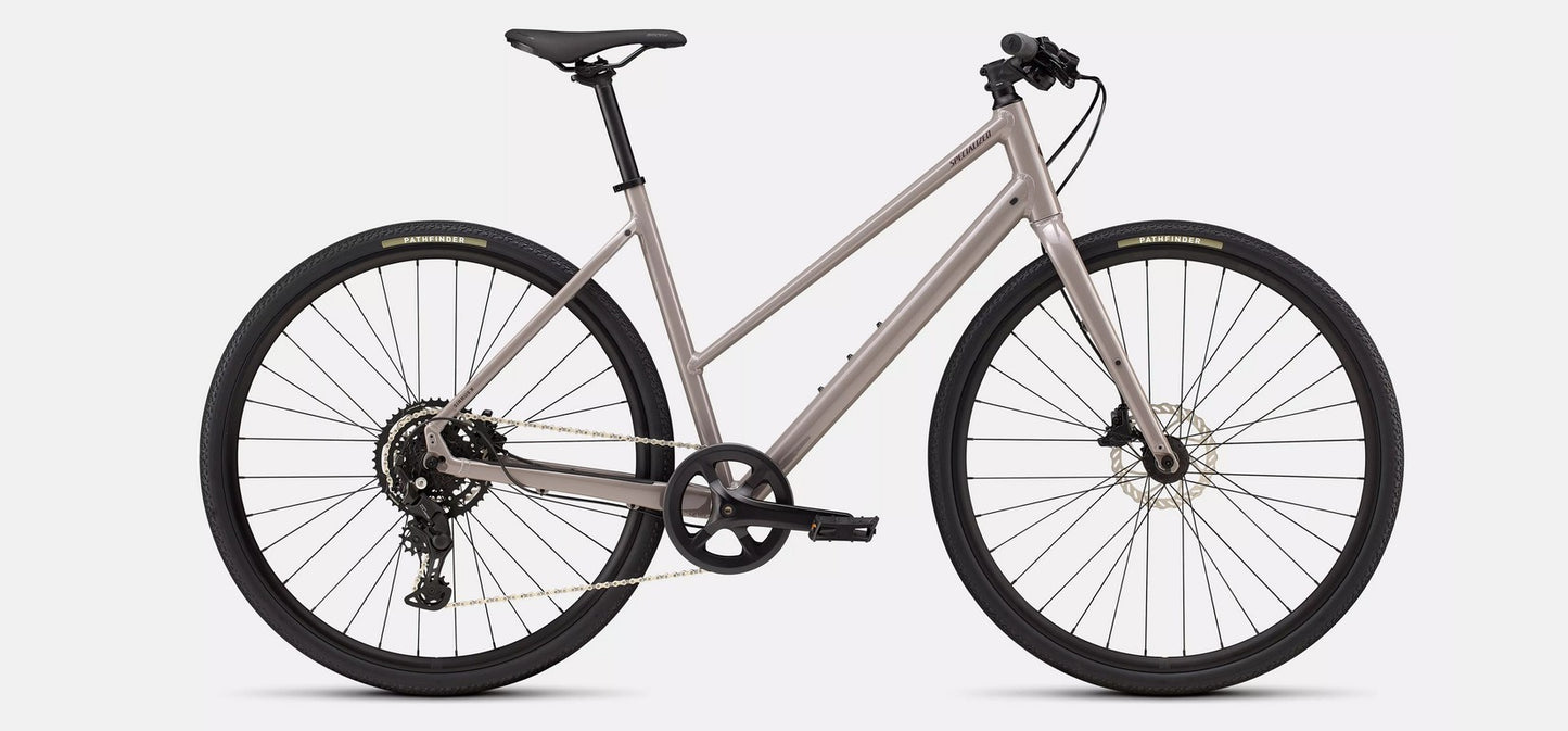 Right profile view of gloss tan Specialized Sirrus bicycle with black components on a white background. 