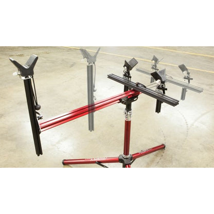 Close-up of three moveable supports on a red repair stand against a white background.