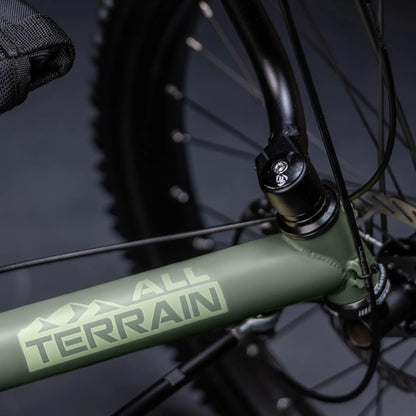Closeup view of the All Terrain frame graphic on the the TerraTrike All Terrain Graphite Grey e-Plus Recumbent Trike against a grey background.