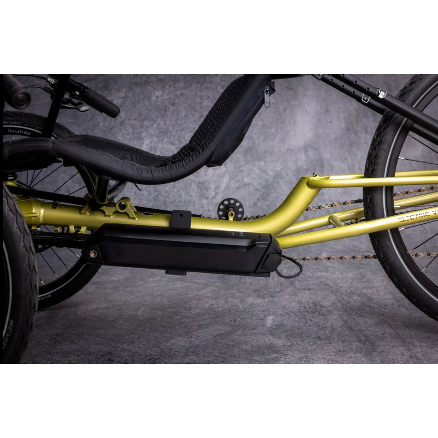 Closeup view of the Bosch battery on the TerraTrike E.V.O. Proton Green Recumbent Trike against a gray background.