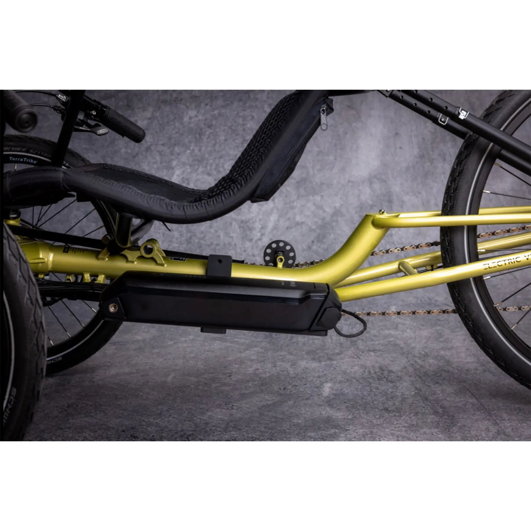 Closeup view of the Bosch battery on the TerraTrike E.V.O. Proton Green Recumbent Trike against a gray background.