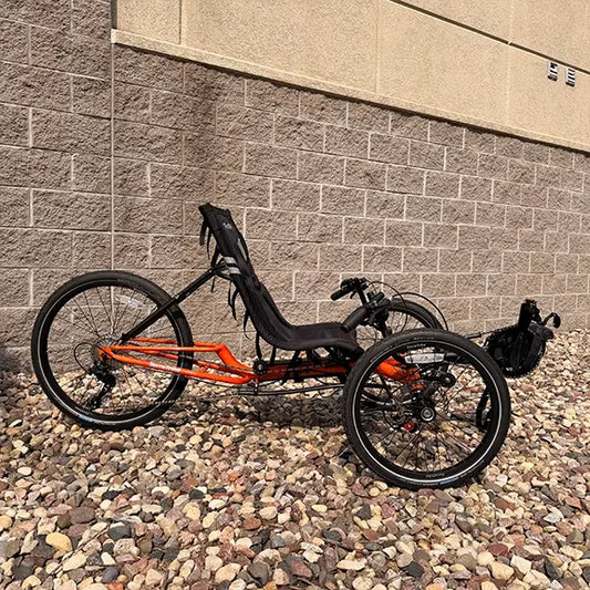 Side view of the TerraTrike Demo Gran Tourismo e-Plus Flame On Recumbent Trike in an outdoor setting.