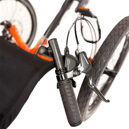 Closeup view of the brake, shifter and handlebar on the TerraTrike Gran Tourismo e-Plus Flame On Recumbent Trike against a white background.