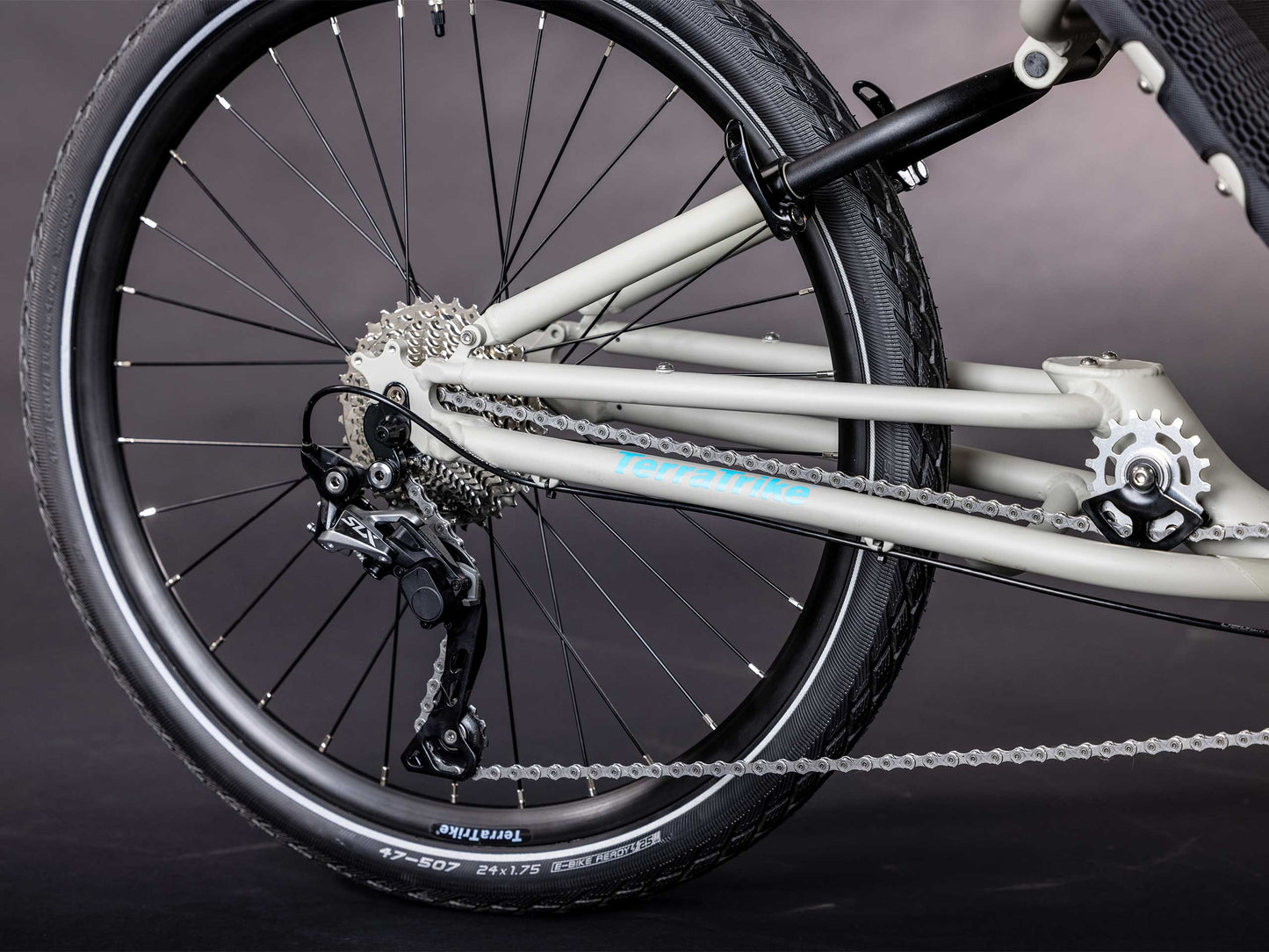 The rear wheel and back end of the drivetrain of the TerraTrike GTS Recumbent Trike in Fog.