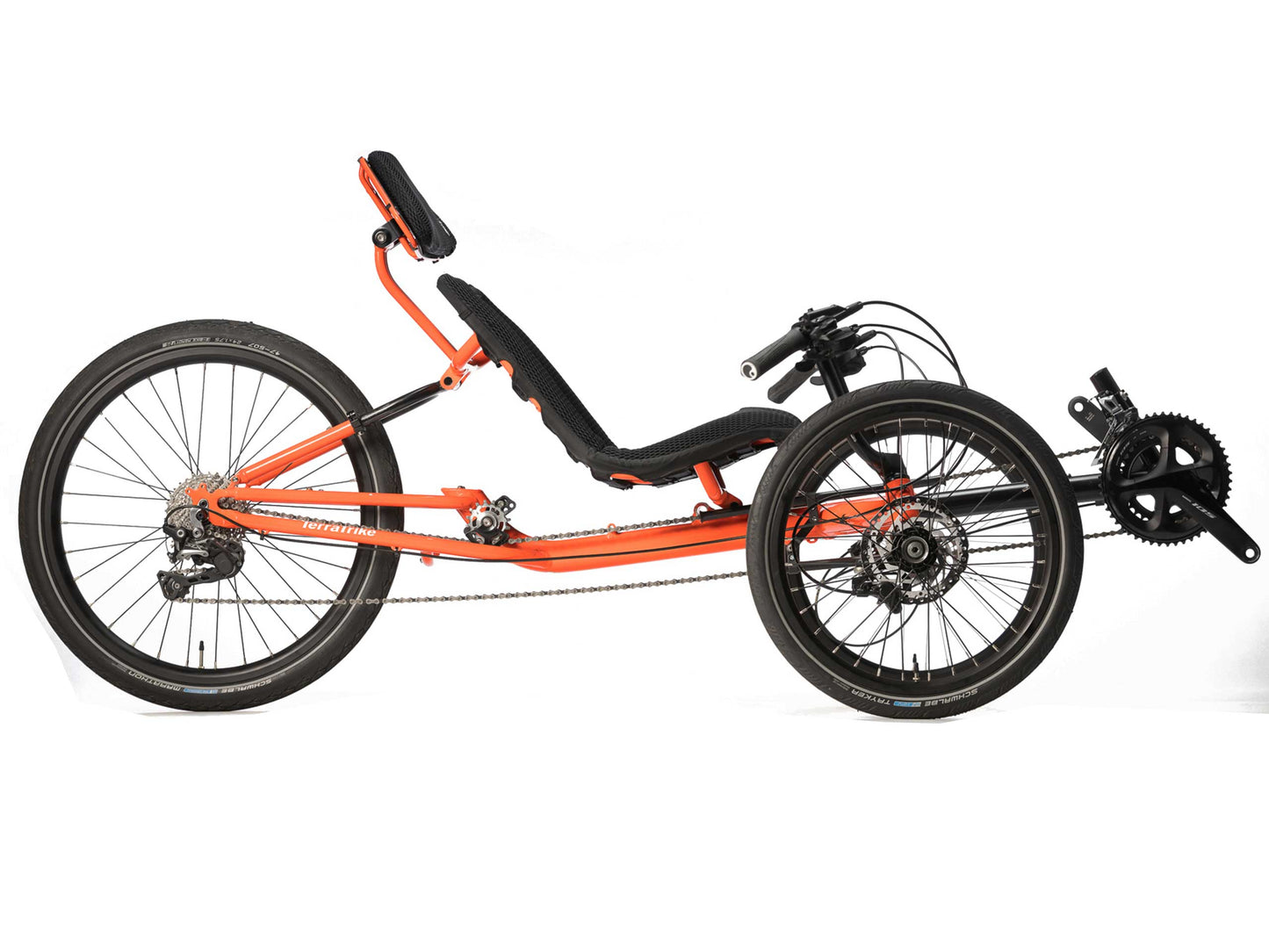 Side view of a TerraTrike GTS Recumbent tadpole trike in Molten (an orange color) with a mesh seat, 24 inch rear wheel and 20 inch front wheels.