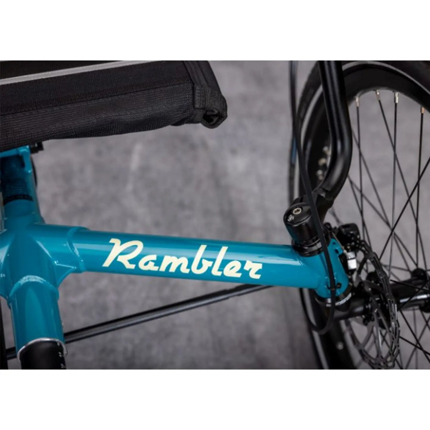 Close-up view of the front frame on the TerraTrike Rambler E-Plus Recumbent Trike in Gemstone against a grey background.