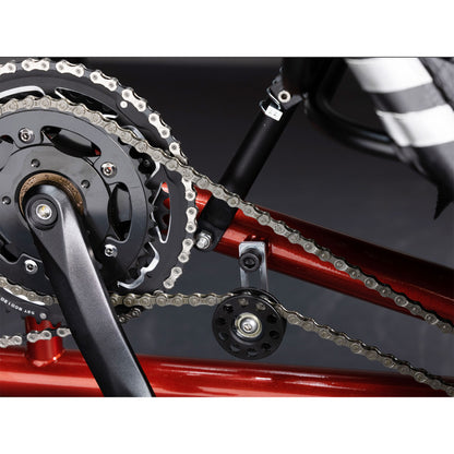 Closeup view of the crankset and idler on the TerraTrike Tandem Pro Sparkle Copper Recumbent Trike against a grey background.