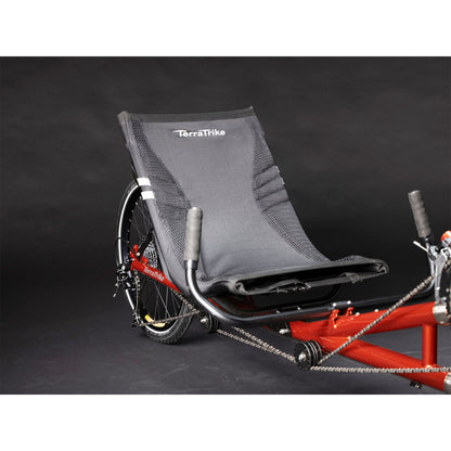 View of the rear seat and wheel on the TerraTrike Tandem Pro Sparkle Copper Recumbent Trike against a grey background.