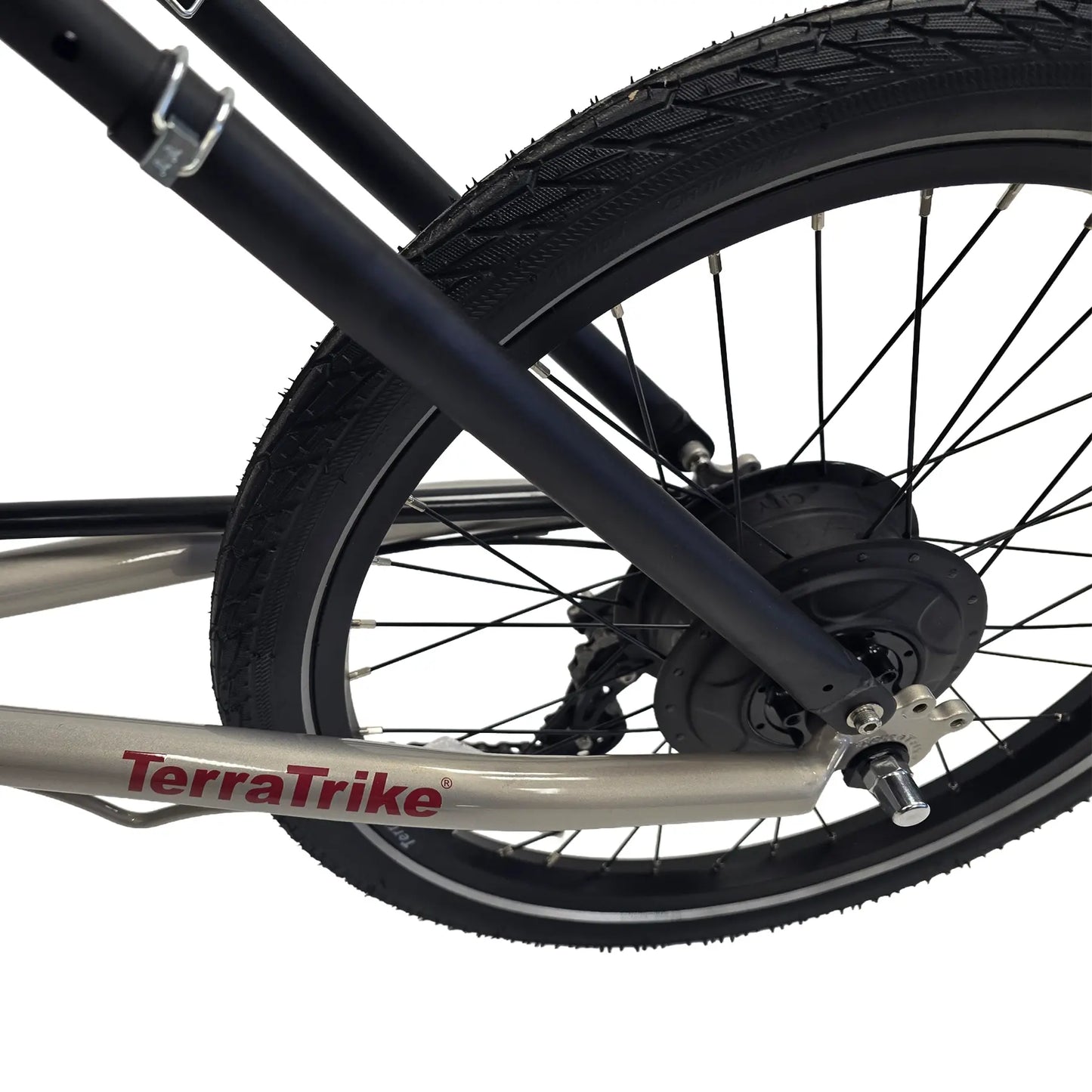 Closeup view of the Enviolo hub and rear wheel on the TerraTrike Traveler Champagne e-Plus Recumbent Trike against a white background.