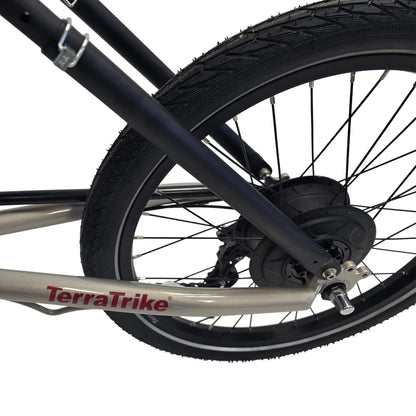 Closeup view of the Enviolo hub and rear wheel on the TerraTrike Traveler Champagne e-Plus Recumbent Trike against a white background.