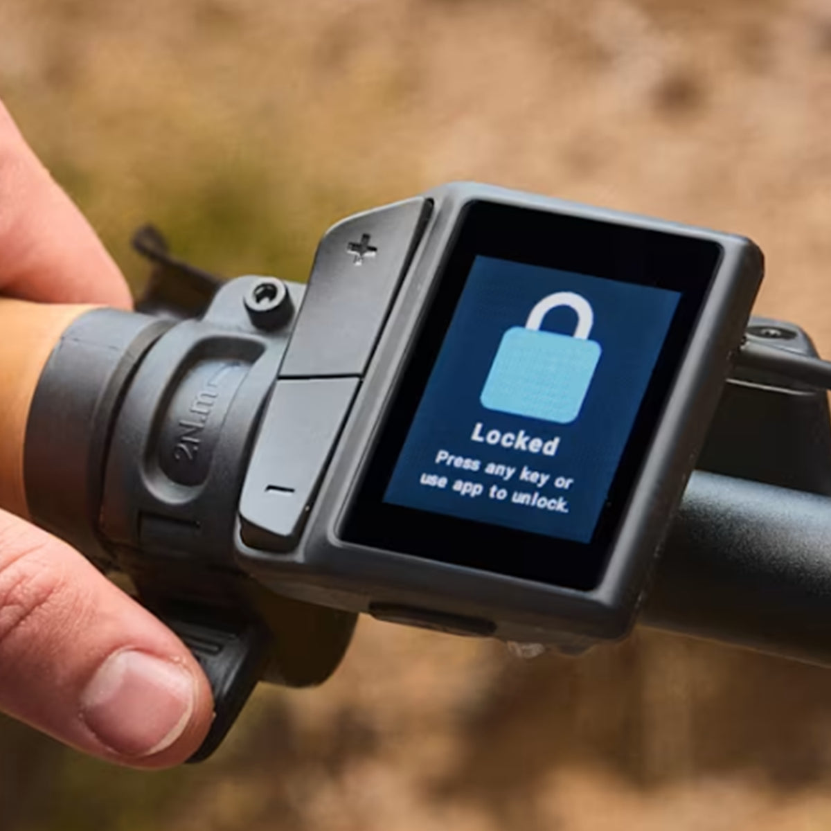 Closeup view of the e-assist controls in the "Lock" setting on the Trek Borrego+ S in a blurred out outdoor setting.