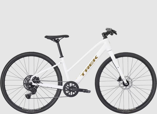 White Trek FX 2 bicycle with black components and gold 'Trek' branding on a light gray background.