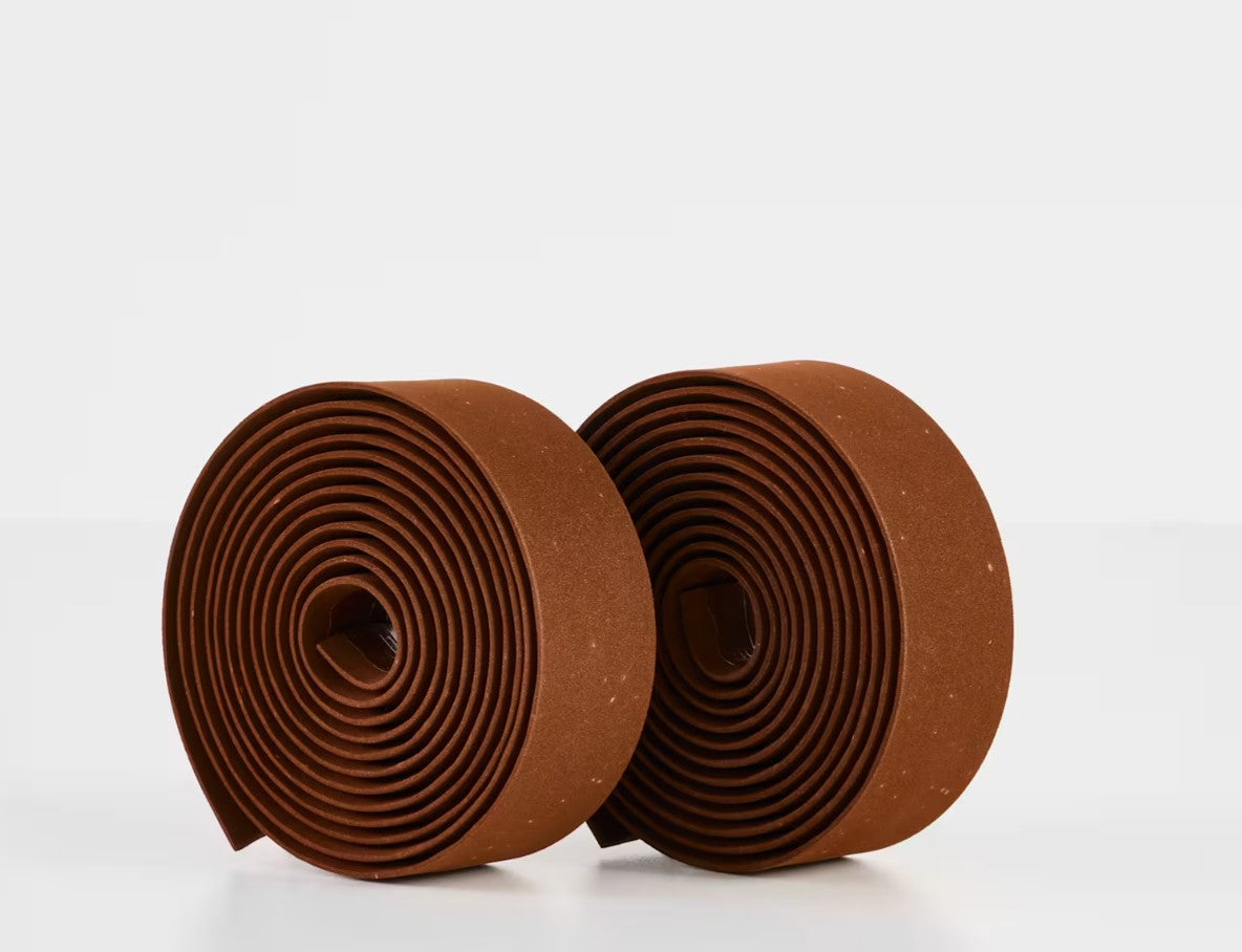 Two rolls of brown Trek gel cork bicycle handlebar tape on a white background.