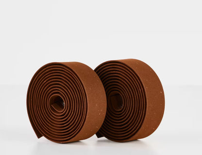 Two rolls of brown Trek gel cork bicycle handlebar tape on a white background.