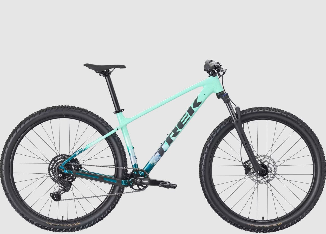 Trek seafoam green Marlin 5 bicycle with black components on a light gray background.