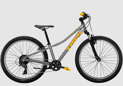 Gray Trek Precaliber bicycle with orange accents on a white background.