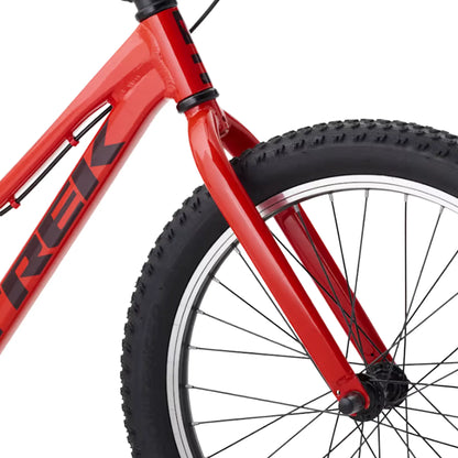 Closeup view of the headtube, fork and front wheel on the Trek Precaliber Kids Single Speed Bike 20 Inch in Radioactive Red against a white background.