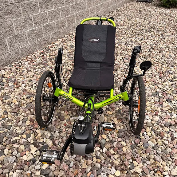 Front view of the Catrike Used 5.5.9 eCat Eon Green Recumbent Trike in an outdoor setting.