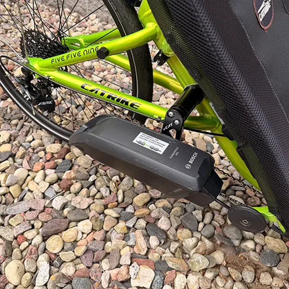 Closeup view of the Bosch battery on the Eon Green Recumbent Trike in an outdoor setting.
