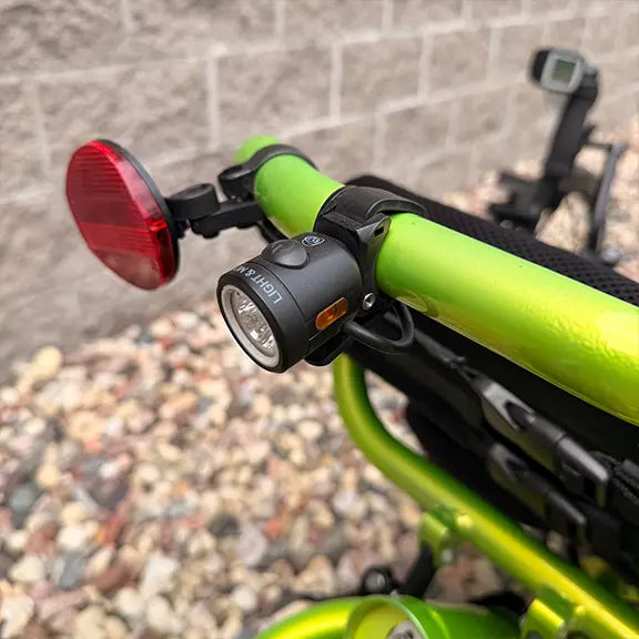 Closeup view of the rear light on the  Catrike Used 5.5.9 eCat Eon Green Recumbent Trike in an outdoor setting.