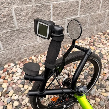 Closeup view of the Bosch e-assist controls, wrist wrest and mirror on the Catrike Used 5.5.9 eCat Eon Green Recumbent Trike in an outdoor setting.