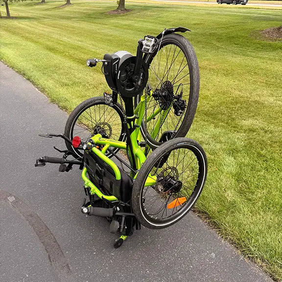 Folded view of the Catrike Used 5.5.9 eCat Eon Green Recumbent Trike in an outdoor setting.