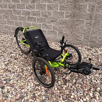 Angled view of the Catrike Used 5.5.9 eCat Eon Green Recumbent Trike in an outdoor setting.