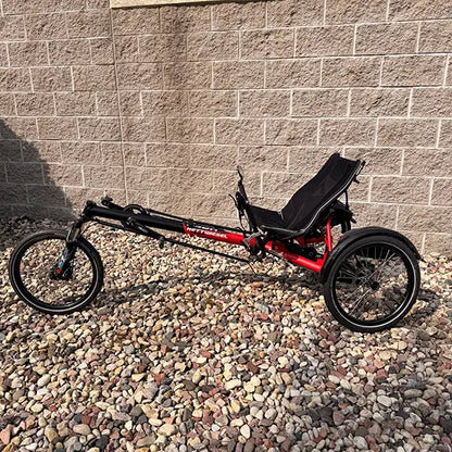 Non-drive side view of the Hase Used Kettwiesel Full Suspension Red Recumbent Trike in an outdoor setting.
