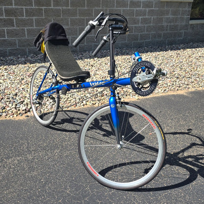 Angled side view of the Volae Used Club Dual 650c Blue Small Recumbent Bike in an outdoor setting.