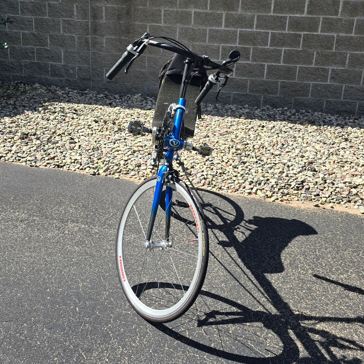 Front view of the Volae Used Club Dual 650c Blue Small Recumbent Bike in an outdoor setting.